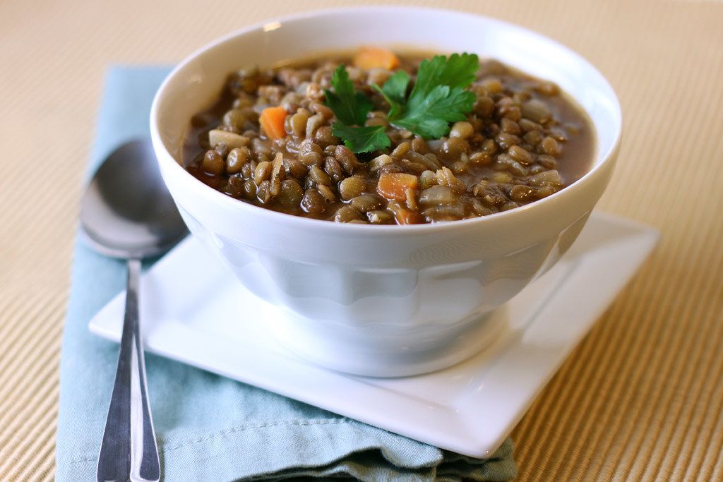 Close up shot of a high protein lentil soup dish on a table.