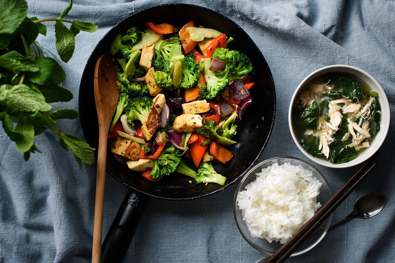An artistic tabling of a high protein stir fry with tofu and broccoli, great for vegetarians.