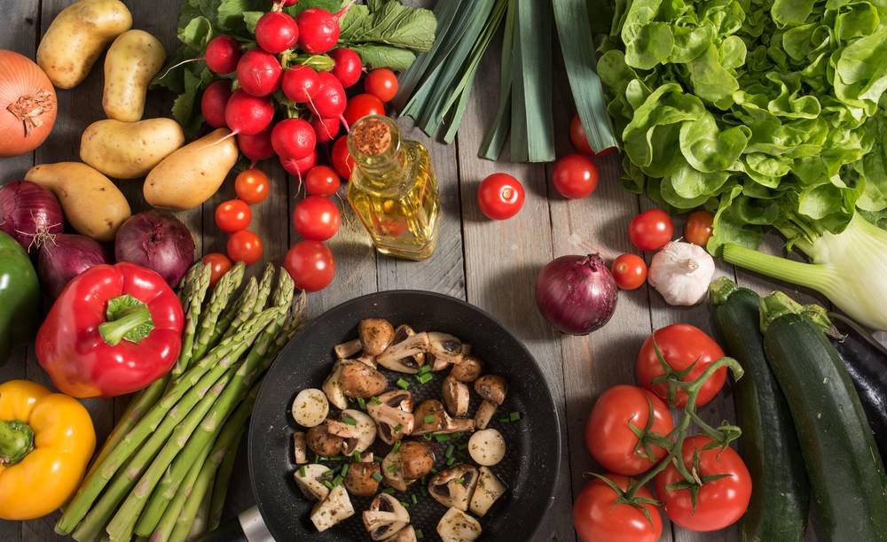 A tantalizing assortment of fresh and vibrant vegetables, including leafy greens, colorful bell peppers, seasoned mushrooms, and juicy tomatoes, creating a mouthwatering display of health and nutrition.