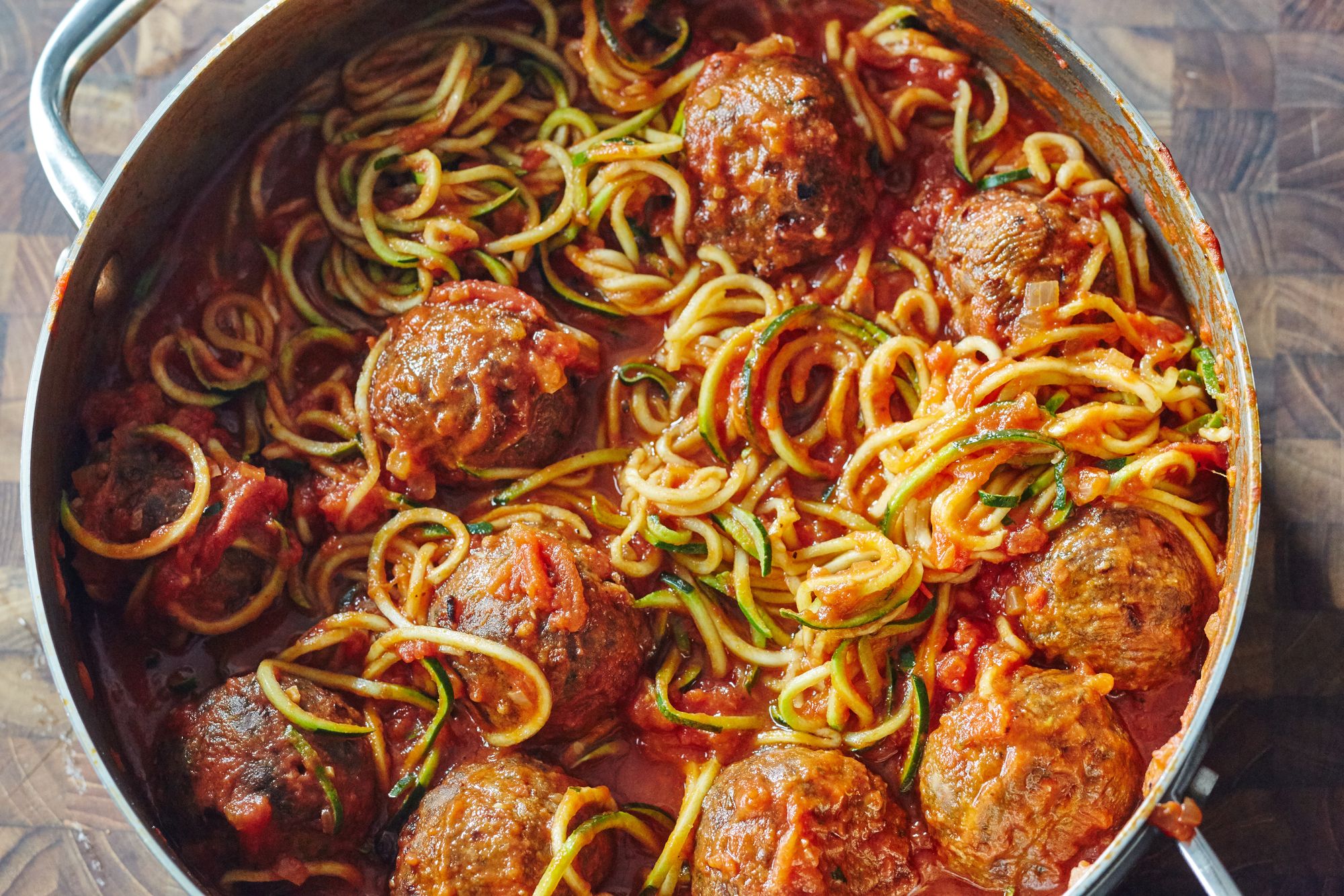 Tantalizing Zucchini Twirls: Delicate Zucchini Noodles Embrace Juicy Meatballs, Bathed in a Rich and Savory Sauce, Creating a Truly Gratifying Culinary Masterpiece.
